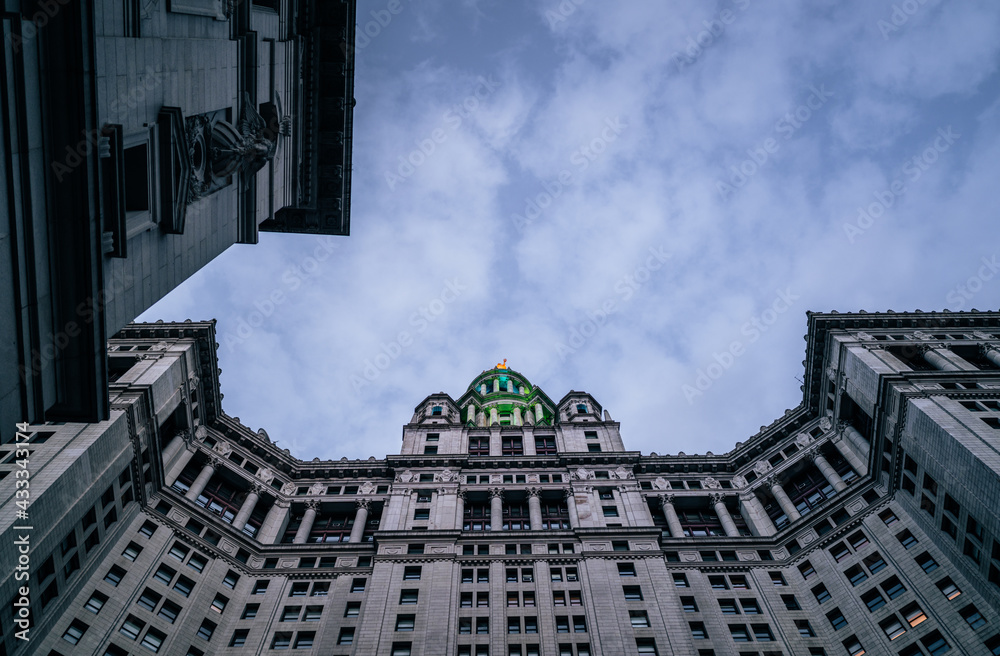 Naklejka premium building in the city old New York City sky blue clouds 