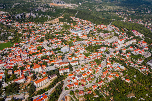 Aerial view of Imotski  a small town in the Dalmatian hinterland with medieval Topana fortress and blue sky. Nature summer landscape  outdoor travel background  Dalmatia  Croatia. August 2020