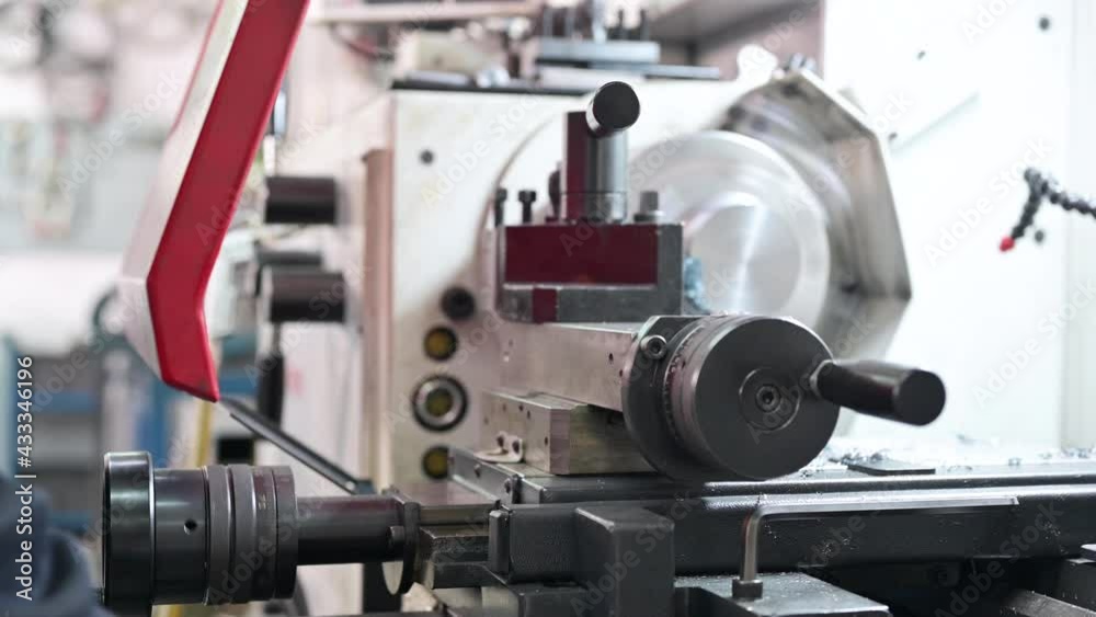 Close up view of worker operating a high precision turning operation on a multi axis lathe, CNC machine tool. High quality 4k footage Close up view of worker operating a high precision turning operation on a multi axis lathe, CNC machine tool. High quality 4k footage