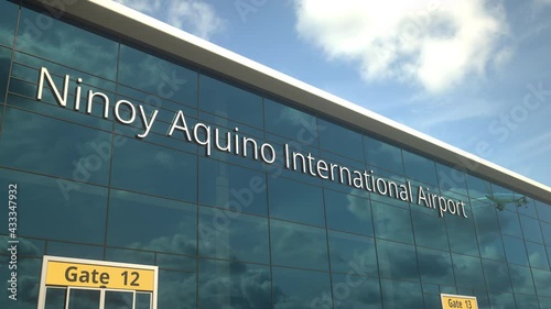 Airliner take off reflecting in the windows with Ninoy Aquino International Airport text photo