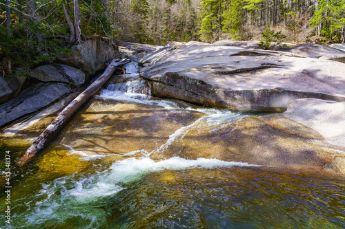 Natural landscape. Waterfall on the Pemigevasset river in the spring among the forest. Lincoln Woods Trail. White Mountains National Forest, NH