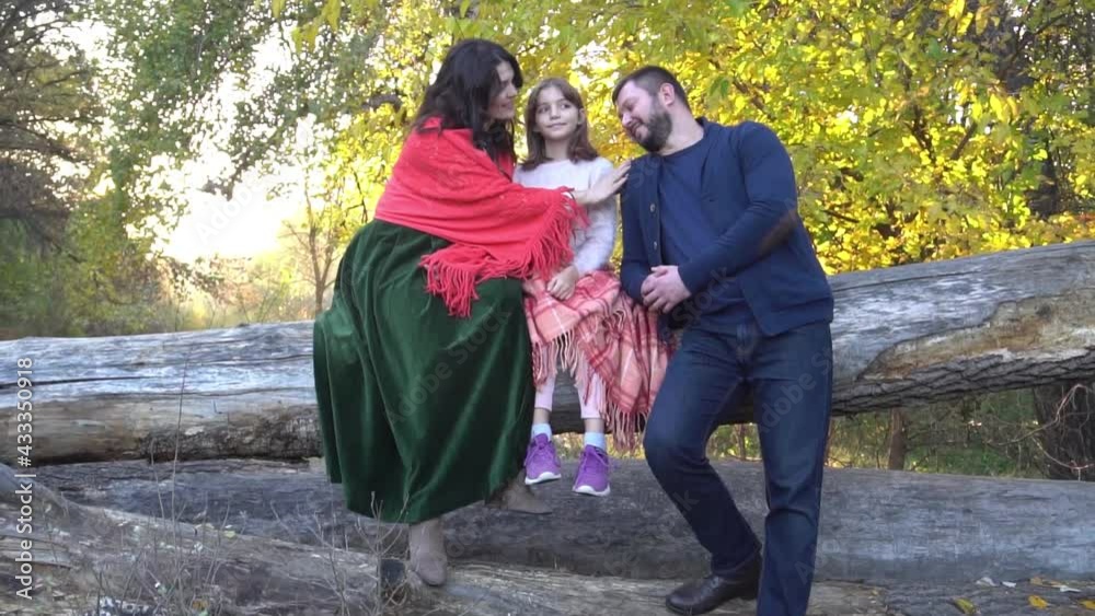 Slow Motion Happy family sitting on bench in beautiful autumn park Slow Motion Happy family sitting on bench in beautiful autumn park