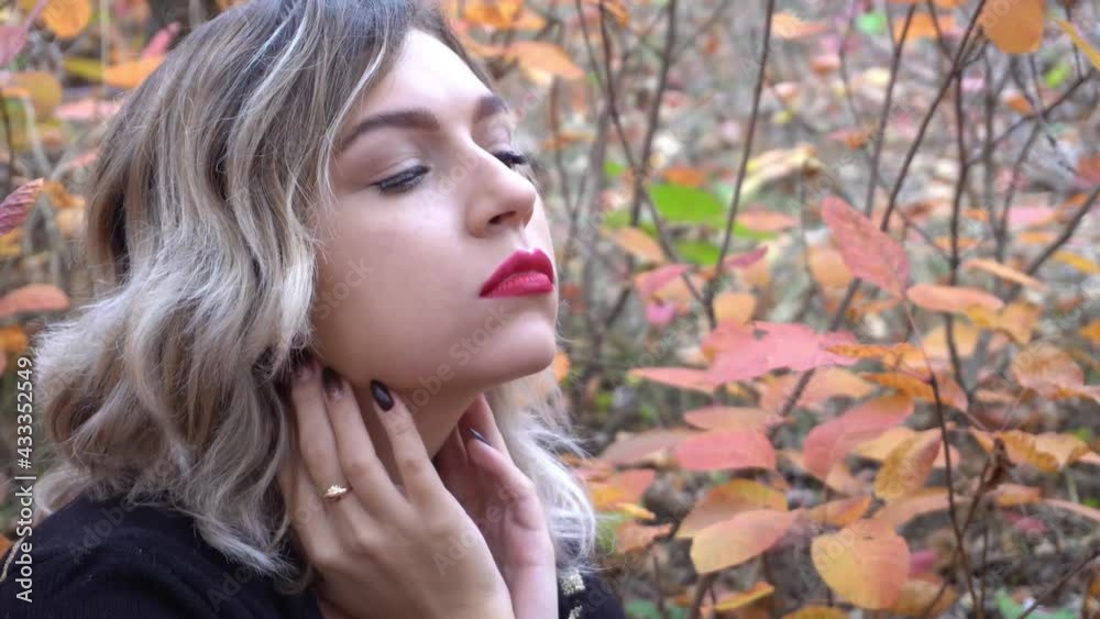 4K Young woman in beautiful autumn park, concept autumn 4K Young woman in beautiful autumn park, concept autumn