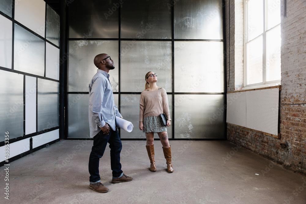 Young business partners looking at new office space Young business partners looking at new office space