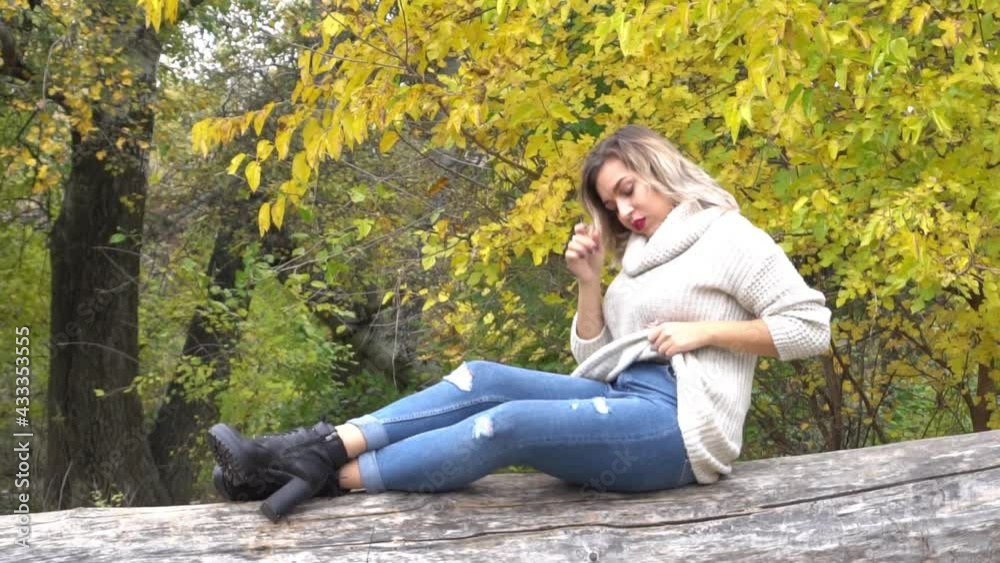 Slow Motion Beautiful young woman over autumn tree background