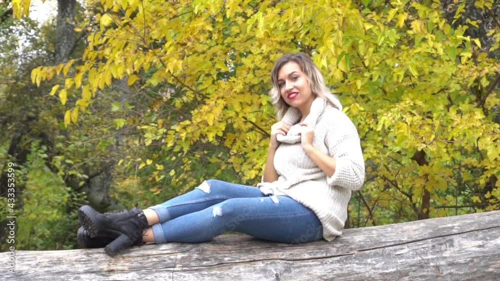 Slow Motion Beautiful elegant woman in a park in autumn Slow Motion Beautiful elegant woman in a park in autumn