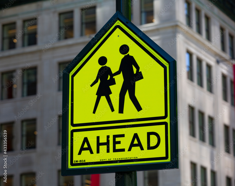 Children crossing street sign with urban background Children crossing street sign with urban background