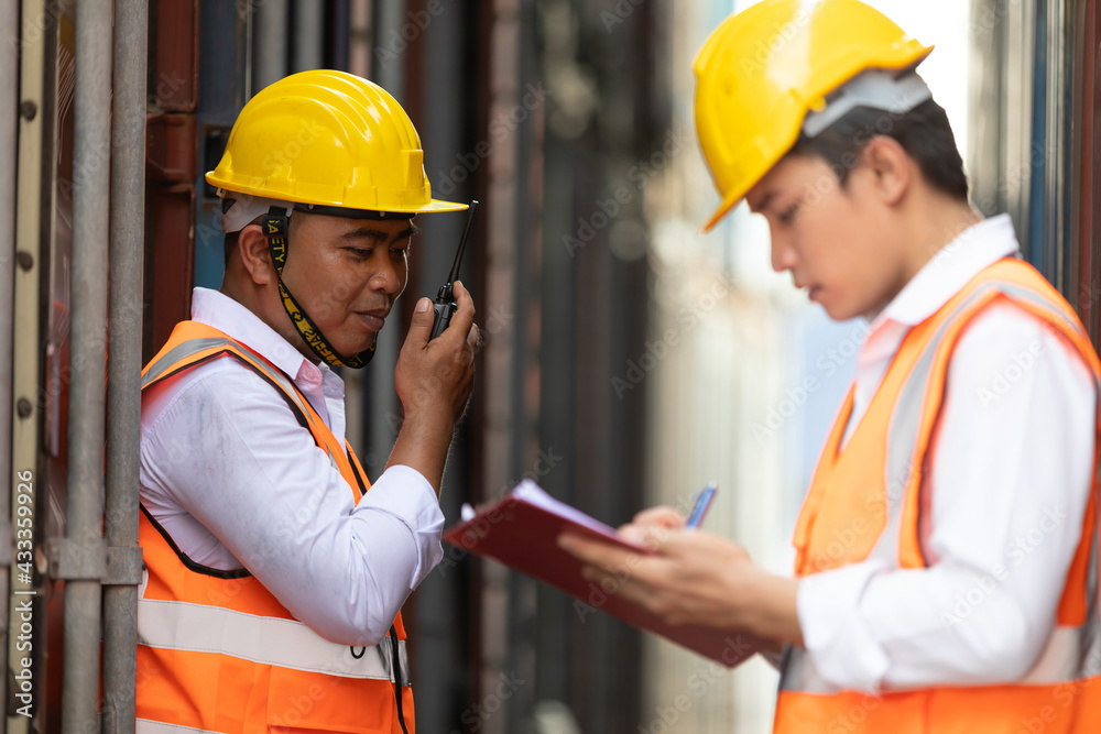 factory worker or engineer using walkie talkie for preparing a job in containers warehouse storage factory worker or engineer using walkie talkie for preparing a job in containers warehouse storage