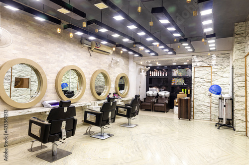 View inside of a modern salon showing mirrors and sitting arrangement. Beauty parlour interiors. photo