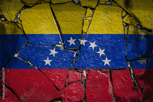 National flag of Venezuela depicting in paint colors on an old stone wall. Flag  banner on broken  wall background. photo
