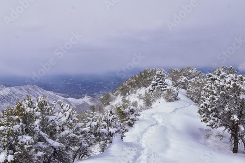 Little Black Mountain Peak hiking trail views by Salt Lake City, in winter snowscape via Bonneville Shoreline Trail, Wasatch Front Rocky Mountains, Utah. United States.