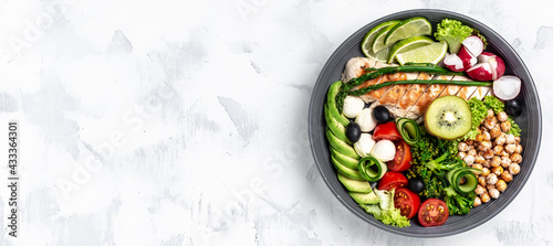 Buddha bowl dish with chicken fillet, asparagus, chickpeas, broccoli, radish, cucumber, avocado, tomatoes, mozzarella. Detox and healthy superfoods bowl concept, top view, flat lay