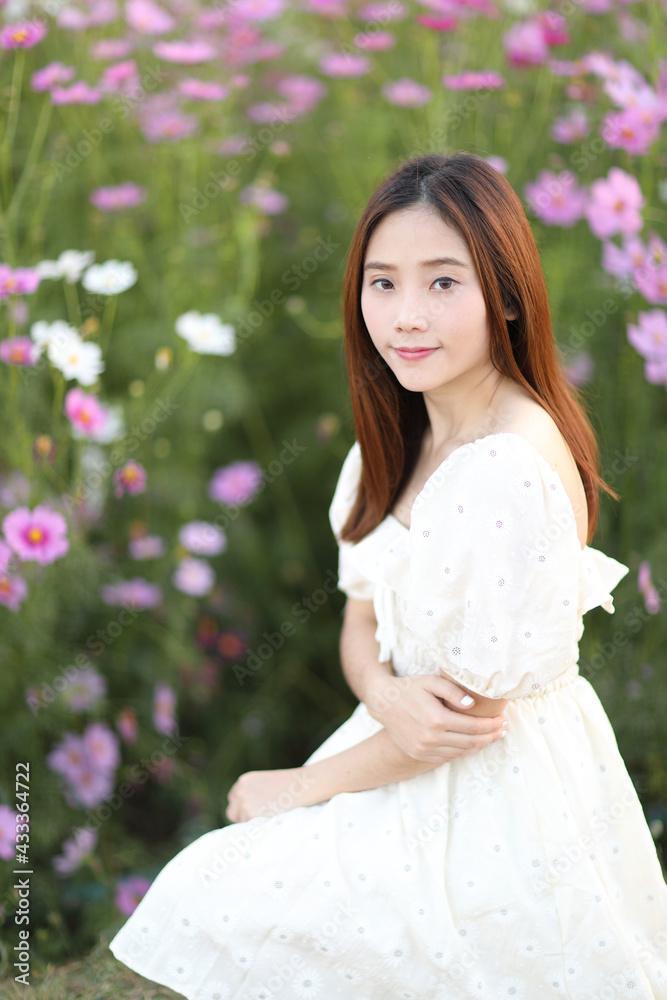 Beautiful young woman with white dress on garden background