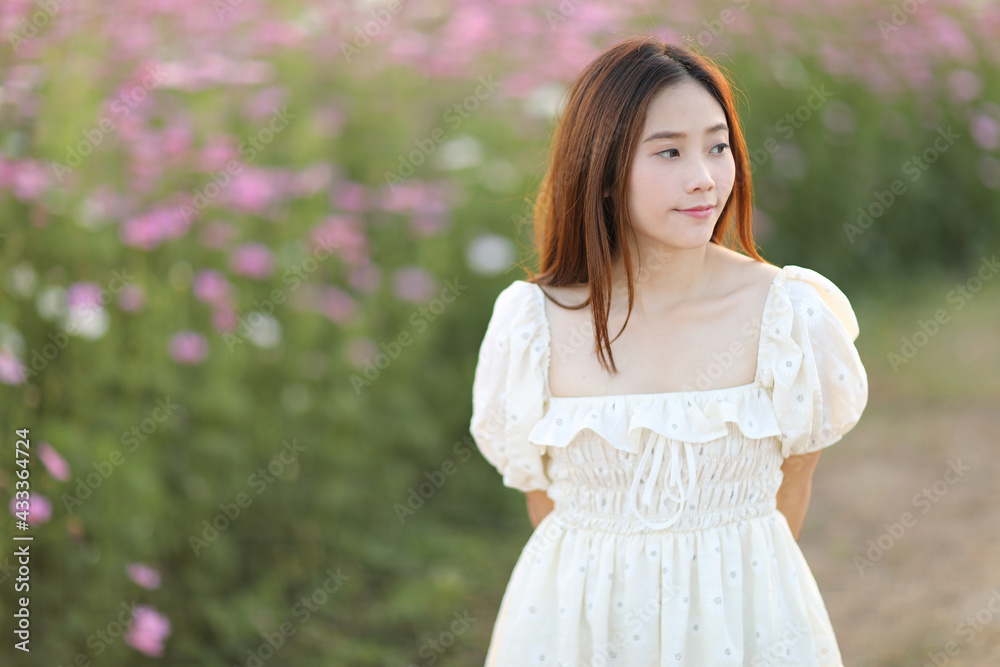 Beautiful young woman with white dress on garden background