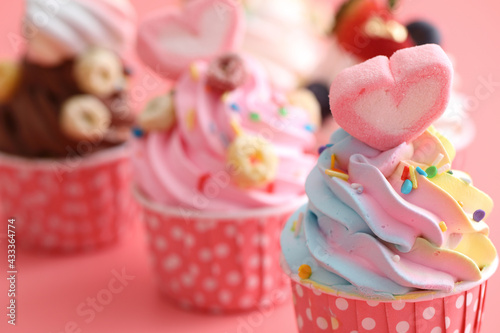 Colorful cupcakes isolated in pink background