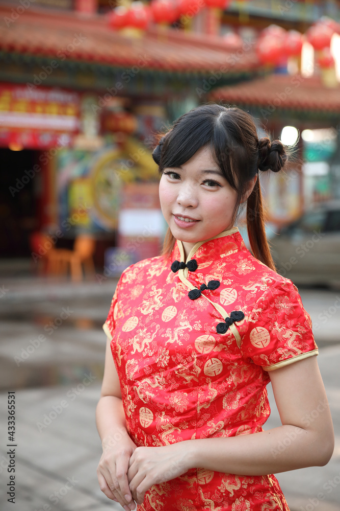 beauty woman wear red cheongsam looking and smile in chinese new year beauty woman wear red cheongsam looking and smile in chinese new year