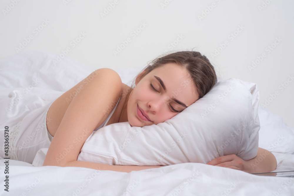 Young woman sleeping well in bed hugging soft white pillow. Girl resting, good night sleep. Woman sleeping. Beautiful young woman lying in bed and keeping eyes closed while covered with blanket. Young woman sleeping well in bed hugging soft white pillow. Girl resting, good night sleep. Woman sleeping. Beautiful young woman lying in bed and keeping eyes closed while covered with blanket.