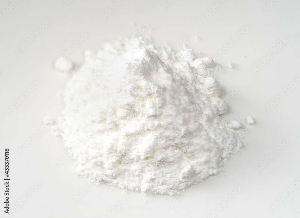 handful of baking powder closeup on white