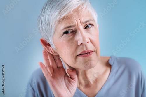 Hearing Loss. Senior Woman with Symptoms of Hearing Loss. photo