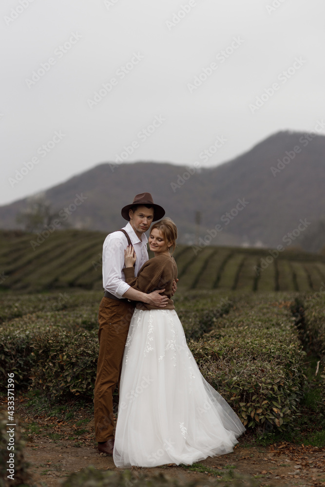 The couple enjoys the view of nature among the tea plantations. A farm-style wedding on a mountain tea plantation.
