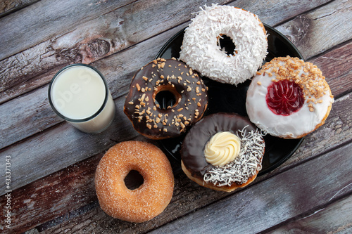 donuts and a glass of milk on the table, doughnuts as dessert, and snack concepts