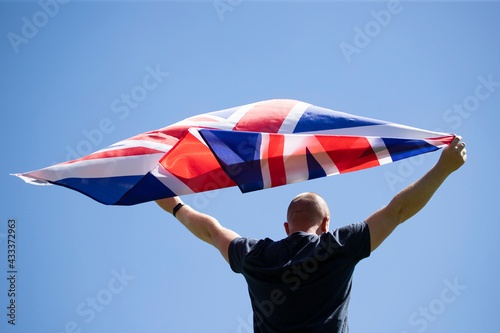  Patriot man holding the United Kingdom flag.