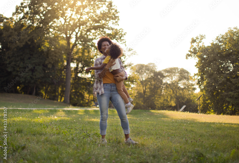 African American father and daughter having fun outdoors. With mom is always fun. African American father and daughter having fun outdoors. With mom is always fun.
