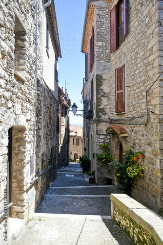 Fototapeta Naklejka Na Ścianę i Meble -  A street between old medieval stone buildings of Bassiano, historic town in Lazio region, Italy.