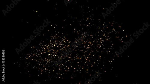 A flock of small golden balls of light emerge as if from a firecracker and slowly move from right to left against a black background.