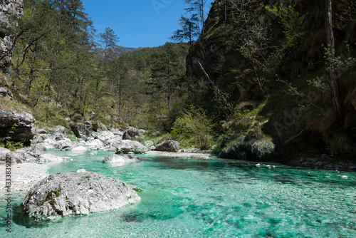 Beautiful mountain creek with emerald waters. This torrent flows between the two villages of Moggessa, Carnic Alps, Moggio Udinese, Udine province, Friuli Venezia Giulia, Italy. photo