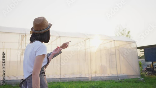 Wallpaper Mural Asian farmer couple talking and walking around their greenhouse. Torontodigital.ca