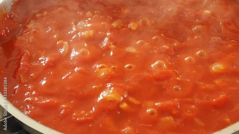 Cook pizza tomato sauce from organic ingredients in a pan Cook pizza tomato sauce from organic ingredients in a pan