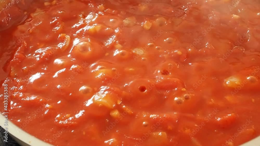 Cook pizza tomato sauce from organic ingredients in a pan Cook pizza tomato sauce from organic ingredients in a pan
