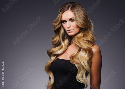 Beautiful woman withblonde hairstyle beauty over dark background
