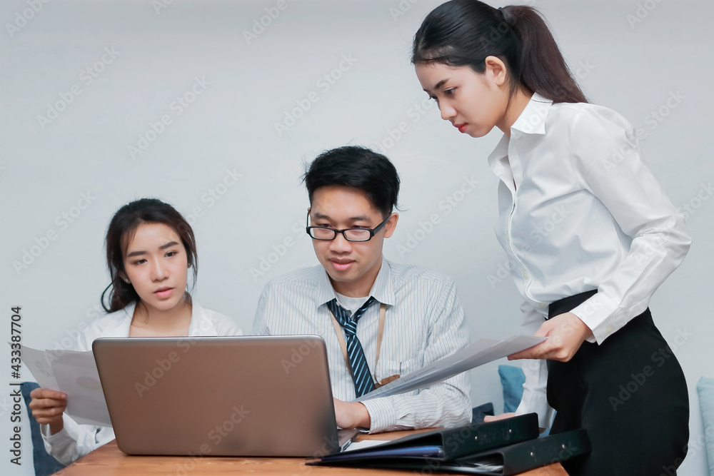 Group of young Asian business people working together in the office. Business teamwork cooperation partnership concept. Group of young Asian business people working together in the office. Business teamwork cooperation partnership concept.