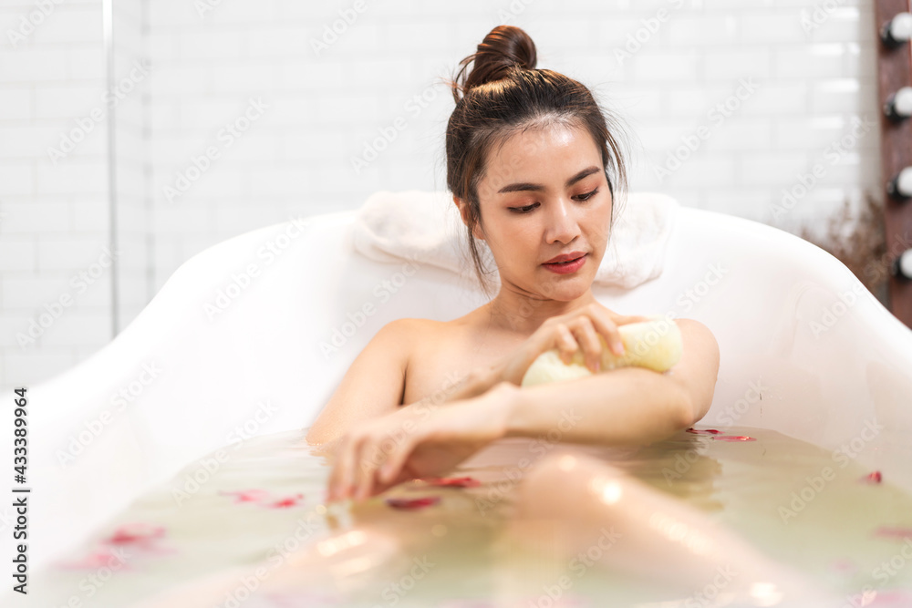 Obraz premium Portrait of smiling of happy beauty pretty asian woman clean fresh healthy white skin spa treatment enjoy relaxing taking shower and bath with bubble foam spa in bathtub at bathroom