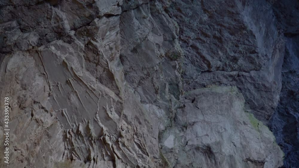 Close up view of limestone underground cave Natural light reflecting the rocks. Underground karst Planina cave in Slovenia. Tilt down Close up view of limestone underground cave Natural light reflecting the rocks. Underground karst Planina cave in Slovenia. Tilt down