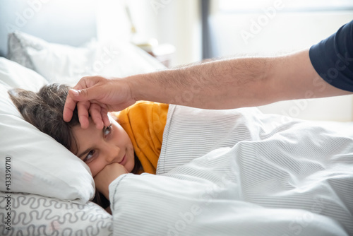 Photos Medium shot of girl lying on bed and pretending to be sick