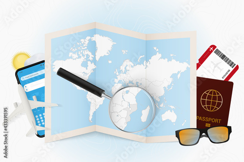 Travel destination Mozambique, tourism mockup with travel equipment and world map with magnifying glass on a Mozambique.