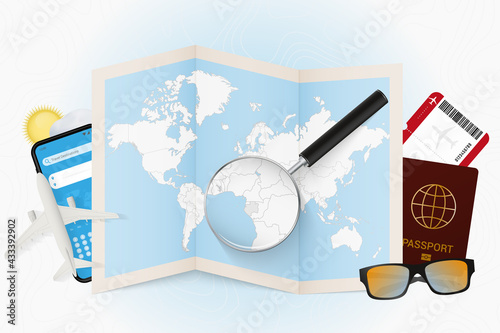 Travel destination Gabon, tourism mockup with travel equipment and world map with magnifying glass on a Gabon.