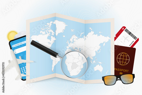 Travel destination Botswana, tourism mockup with travel equipment and world map with magnifying glass on a Botswana.