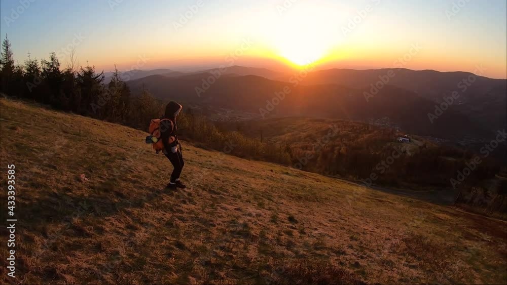 Girl walking down during sunset in mountains Girl walking down during sunset in mountains