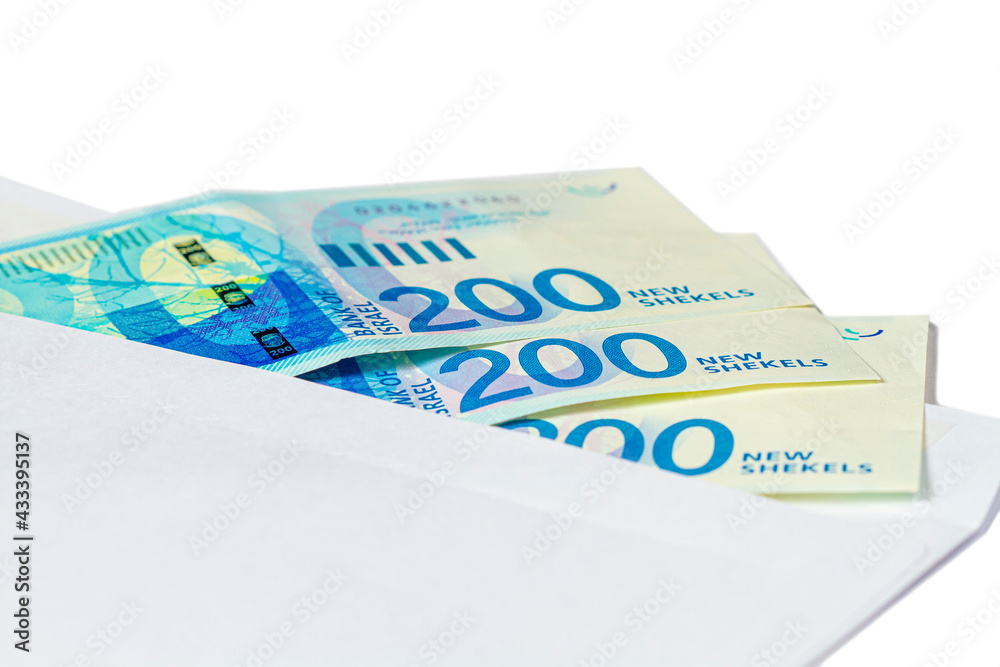 Three banknotes of 200 new Israeli shekels in a mail envelope on a white isolated background. Three banknotes of 200 new Israeli shekels in a mail envelope on a white isolated background.