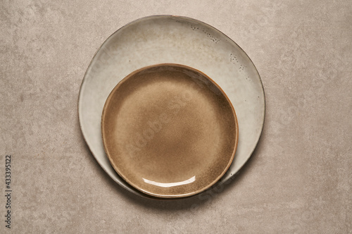  beige ceramic plates on stone