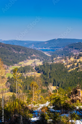 Germany  Schwarzwald view from snow covered feldberg mountain over black forest  titisee lake and houses between the trees in beautiful nature landscape