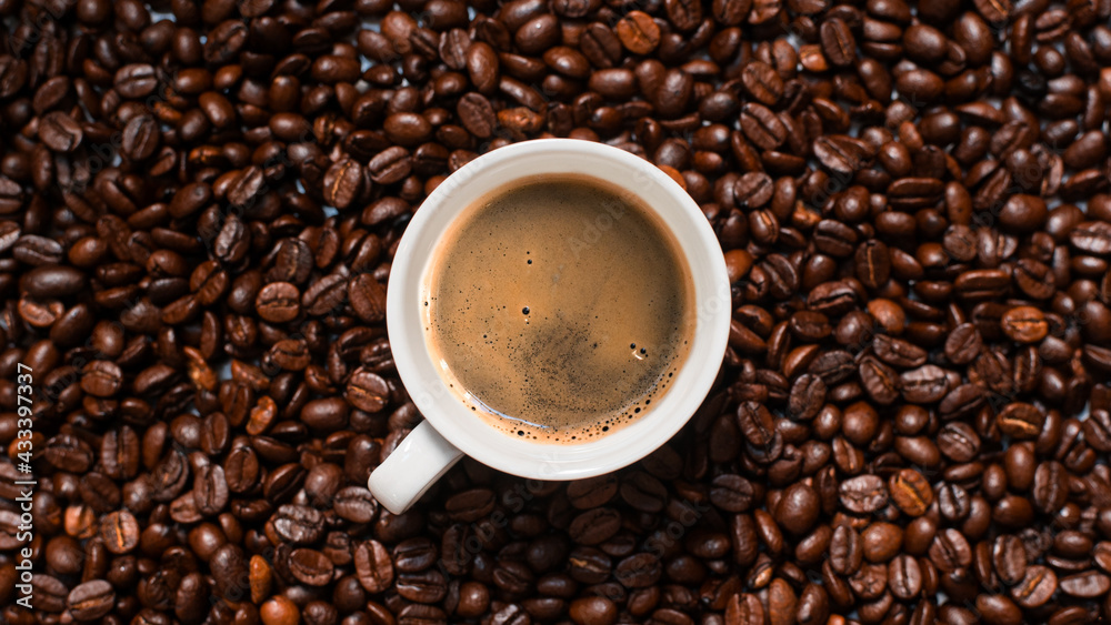 Cup of coffee with beans on table, top view Cup of coffee with beans on table, top view