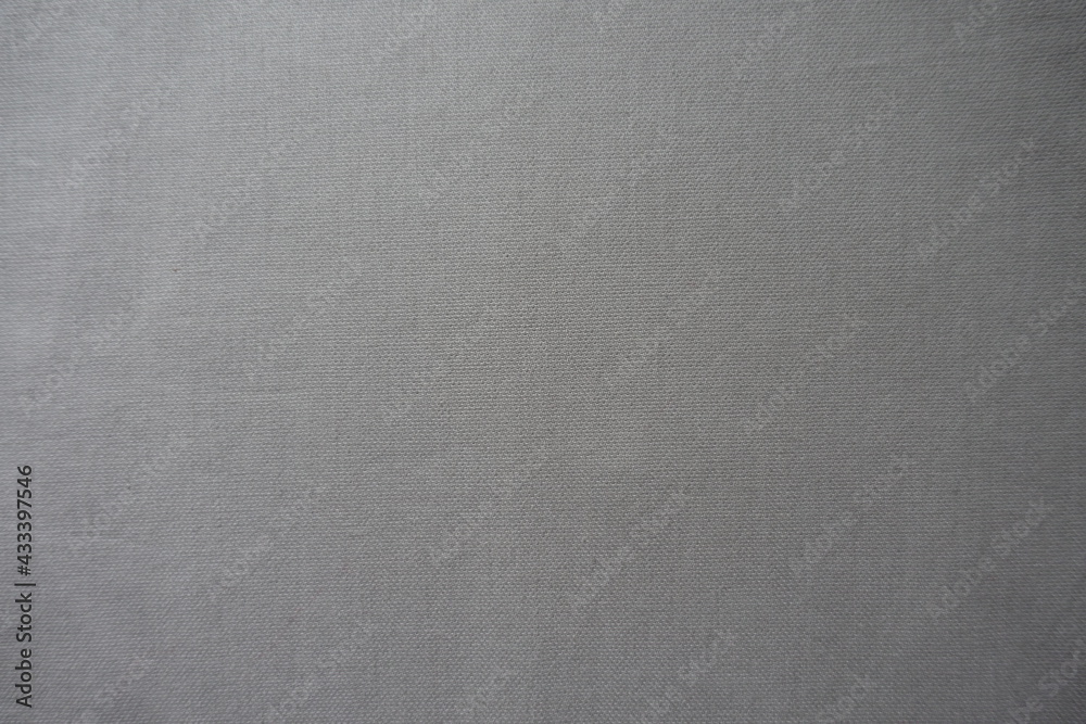 Texture of simple light grey cotton fabric from above Texture of simple light grey cotton fabric from above