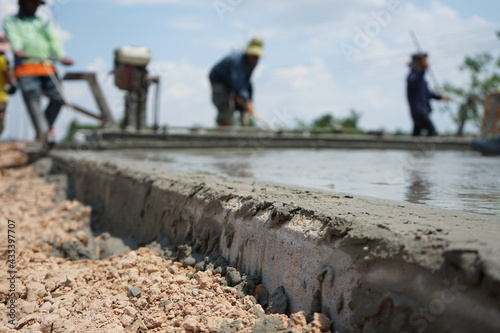 Blurred image of concrete pouring By manual labor