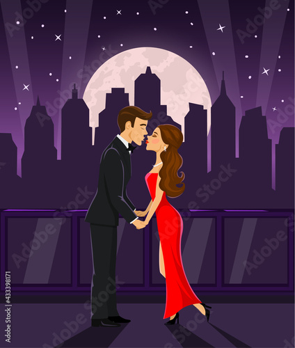 Romantic couple standing on a terrace with night city view, holding hands and kissing