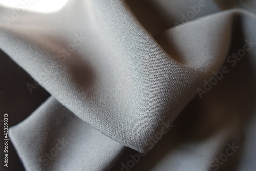 Gray viscose and polyester fabric in soft folds